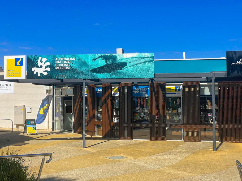 The front of a building in a small plaza with sign "Australian National Surfing Museum" above it