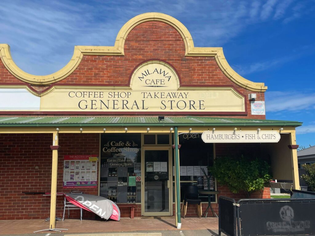 Exterior of Milawa General Store, an old brick building with a sign advertising that it's also a cafe, coffee shop, and takeway. 