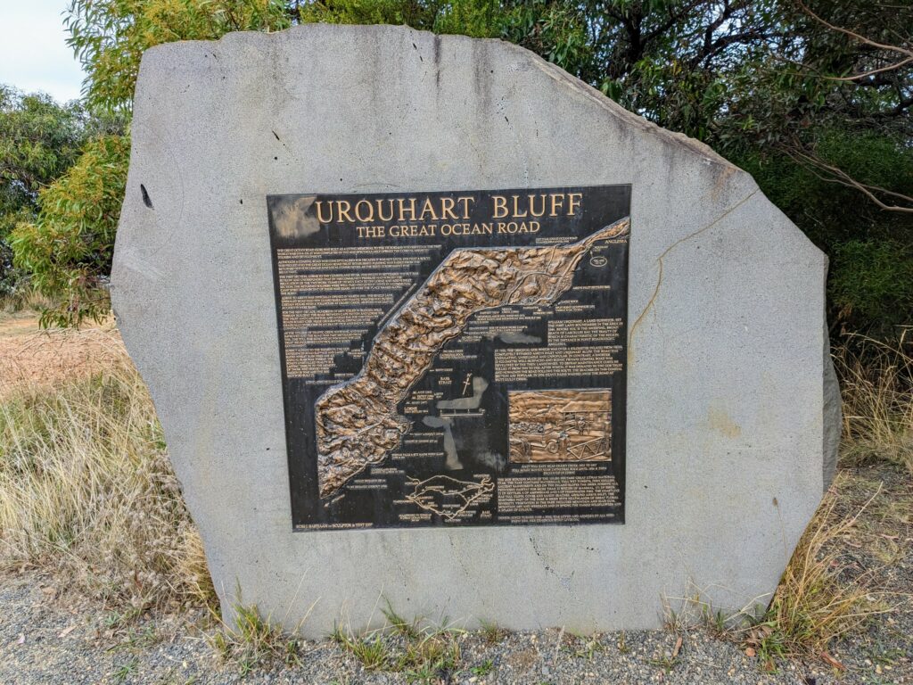 Large stone inlaid with an informational sign about Urquhart Bluff. Sign has 3D map of the surrounding area, with several paragraphs of information alongside.