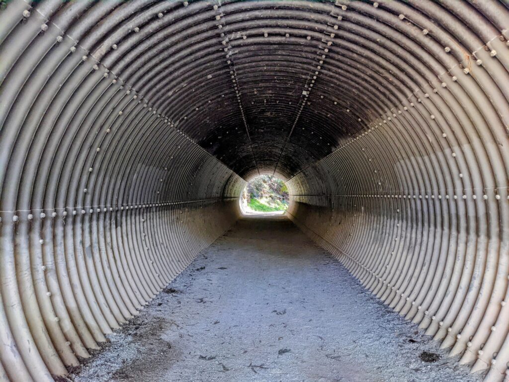 Metal tunnel that goes underneath a road on the Lilydale to Warburton rail trail