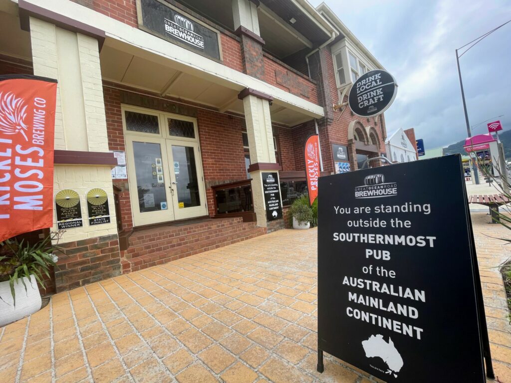 The exterior of a brick pub in Apollo Bay, with a sign outside saying "You are standing outside the southernmost pub of the Australian mainland continent"